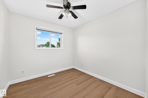 Wood-finish flooring, white walls, and a ceiling fan with light fixture - 3924 26A Avenue Nw, Edmonton, AB 