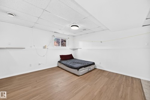 Wood-finish flooring, white walls, and a drop ceiling with recessed lighting - 3924 26A Avenue Nw, Edmonton, AB 