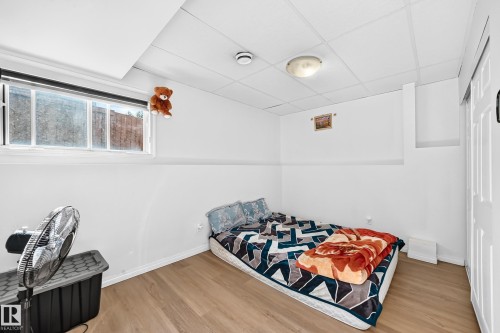Recessed window, wood-finish flooring, white walls, drop ceiling, flush-mount ceiling light - 3924 26A Avenue Nw, Edmonton, AB 