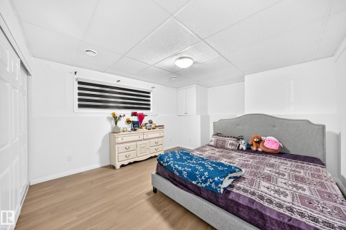 White walls with a two-tone finish, wood-finish flooring, and a drop ceiling - 3924 26A Avenue Nw, Edmonton, AB 