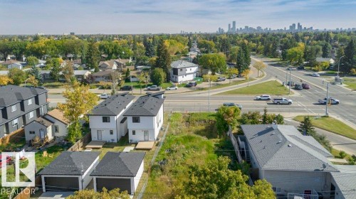 Contemporary townhome with a dark shingle roof, white exterior, and private rear deck - 10712 149 Street Nw, Edmonton, AB 