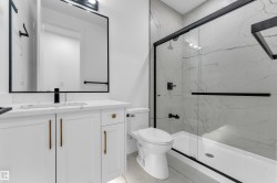 White vanity with gold-finish hardware, rectangular undermount sink, and black matte faucet - 