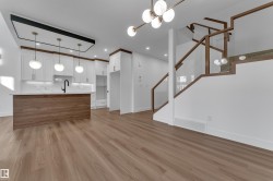 Open-concept space featuring wood-finish flooring - 