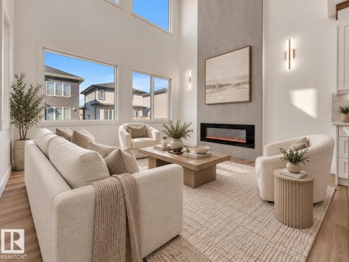 Vaulted ceiling with extensive window placement, contemporary linear fireplace with stone-finish surround, wall-mounted sconce lighting, and wood-finish flooring - 3604 44 Avenue, Beaumont, AB 