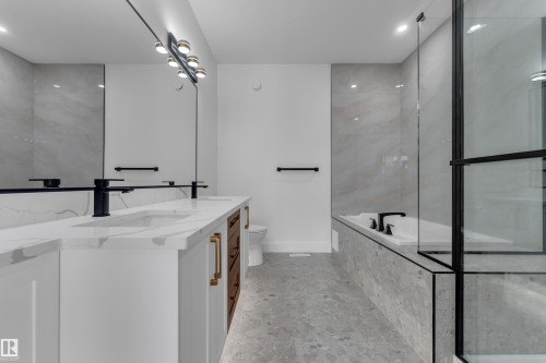 Dual vanity with white cabinetry, wood-finish drawers, and gold-tone hardware - 3604 44 Avenue, Beaumont, AB 