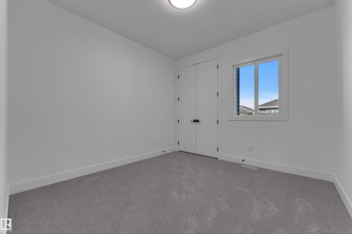 White walls, gray carpet, and a window with white trim - 3604 44 Avenue, Beaumont, AB 