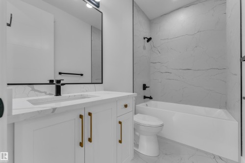 White vanity with gold-tone hardware, rectangular undermount sink, and black faucet - 3604 44 Avenue, Beaumont, AB 