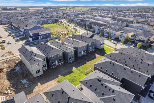 Modern residential development featuring multiple detached homes with dark shingle roofs - 3604 44 Avenue, Beaumont, AB 