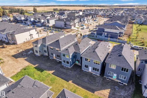 Modern residential development featuring multi-story properties with dark shingle roofing and varied exterior siding - 3604 44 Avenue, Beaumont, AB 