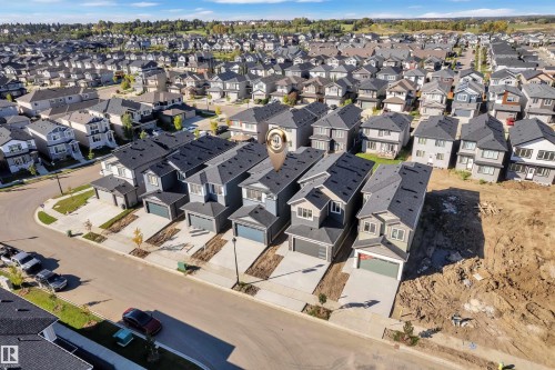 Newly constructed homes featuring attached garages, paved driveways, and modern exterior finishes - 3604 44 Avenue, Beaumont, AB 