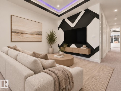 Recessed ceiling lighting, tray ceiling with accent lighting, accent wall with geometric design, wall-mounted media console, and carpet flooring - 3604 44 Avenue, Beaumont, AB 