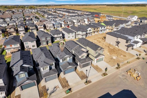 Newly constructed residence featuring a two-story design, attached garage, and a contemporary architectural style with dark roofing - 3604 44 Avenue, Beaumont, AB 