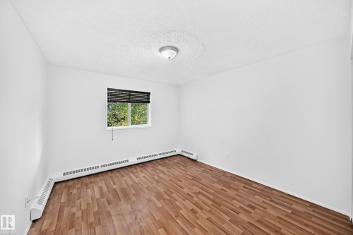 Wood-finish flooring, white walls, and a ceiling-mounted light fixture - #212 11218 80 St Nw, Edmonton, AB 