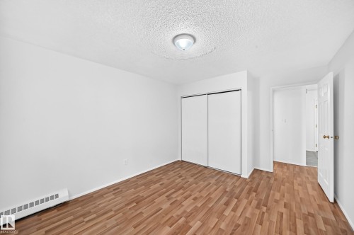 Wood-finish flooring, white walls, and a ceiling-mounted light fixture - #212 11218 80 St Nw, Edmonton, AB 