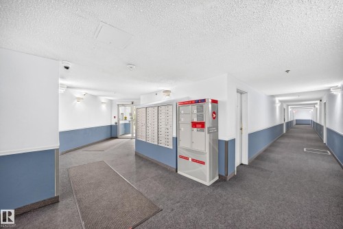 Mailboxes with integrated package delivery, recessed lighting, wall-mounted sconces, and durable flooring - #212 11218 80 St Nw, Edmonton, AB 