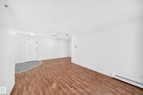 Entryway with tiled flooring, wood-finish flooring, and white walls - #212 11218 80 St Nw, Edmonton, AB 
