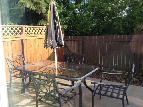 Paved patio area enclosed by wood fencing with integrated lattice detailing - 55 Royal Road Nw, Edmonton, AB 