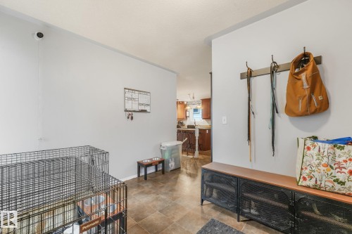 Neutral tile flooring and wall-mounted metal coat rack - 9617 151 Street Nw, Edmonton, AB 