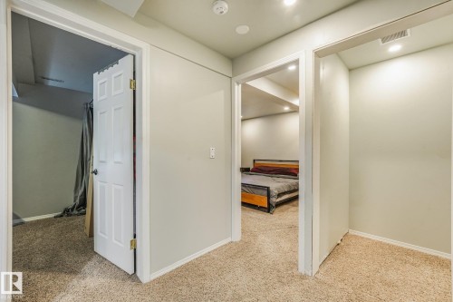 Neutral wall finishes, textured carpeting, and white interior door and window casing - 9617 151 Street Nw, Edmonton, AB 