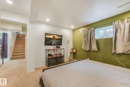 Interior room featuring neutral wall tones, an olive accent wall, recessed lighting, and carpeted flooring - 9617 151 Street Nw, Edmonton, AB 