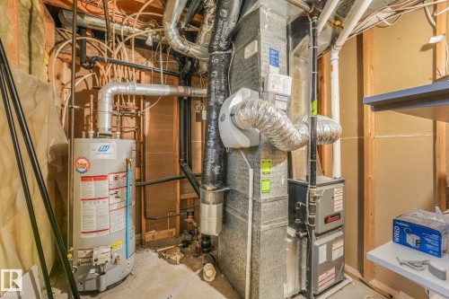 Utility area featuring a water heater, forced-air furnace, and integrated ductwork system - 9617 151 Street Nw, Edmonton, AB 