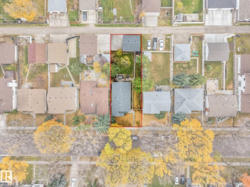 Aerial perspective of a residential property featuring a detached garage, concrete driveway, and mature landscaping - 9617 151 Street Nw, Edmonton, AB 