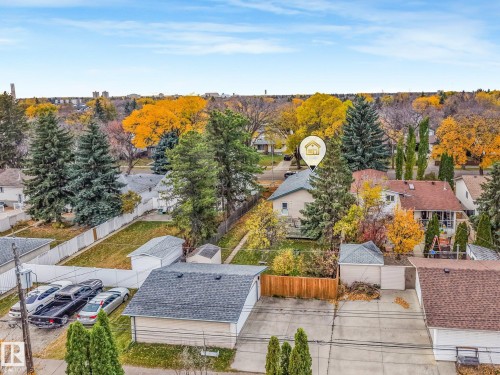 Aerial view featuring a detached garage, concrete driveway, and mature landscaping - 9617 151 Street Nw, Edmonton, AB 