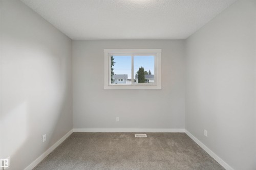 Neutral wall color, window with white trim, gray carpeting - 13212 73 Street Nw, Edmonton, AB 