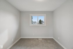 Neutral wall color, window with white trim, gray carpeting - 