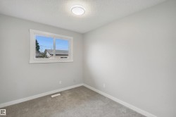 Light gray carpeted flooring, white trim, and a white-framed window - 