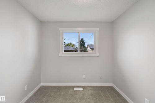 Neutral wall color, window with white trim, and gray carpet - 13212 73 Street Nw, Edmonton, AB 
