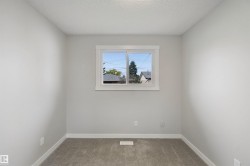 Neutral wall color, window with white trim, and gray carpet - 