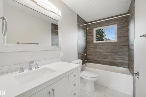 Contemporary vanity with an integrated rectangular sink and polished chrome faucet - 13212 73 Street Nw, Edmonton, AB 