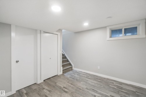 Recessed ceiling lighting, wood-finish flooring, white trim, white walls, and a window with white casing - 13212 73 Street Nw, Edmonton, AB 