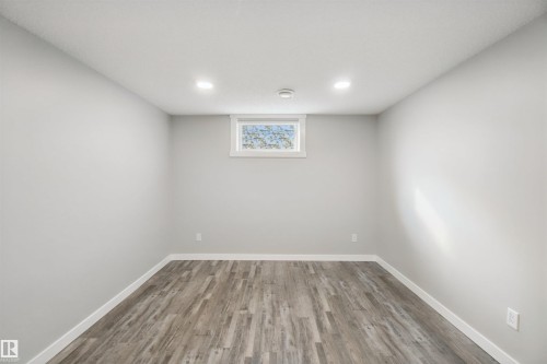 Recessed lighting illuminates this room, featuring wood-finish flooring and a single window - 13212 73 Street Nw, Edmonton, AB 