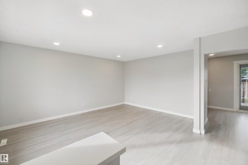 Recessed ceiling lighting, light gray wall finishes, wood-finish flooring, and white trim - 13212 73 Street Nw, Edmonton, AB 