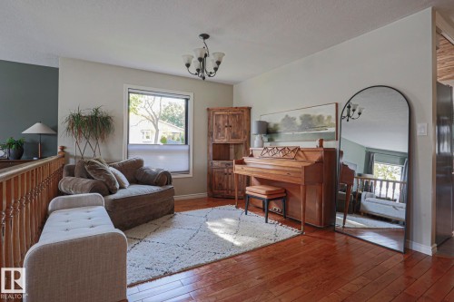 Hardwood flooring, chandelier lighting, window with blinds, and painted walls - 2 Hillview Crescent, Sherwood Park, AB 