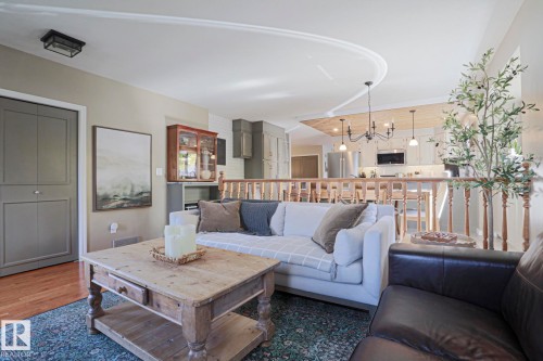 Wood-finish flooring, wood balustrade, recessed lighting, chandelier, and a wood-finish coffee table - 2 Hillview Crescent, Sherwood Park, AB 