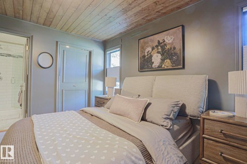 Wood-paneled ceiling, painted walls, and a built-in closet with panel doors - 2 Hillview Crescent, Sherwood Park, AB 