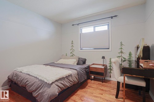 Bright window with cellular shades, wood-finish flooring, and white trim - 2 Hillview Crescent, Sherwood Park, AB 
