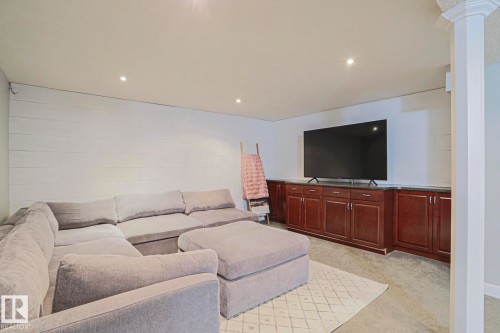 Recessed lighting, white shiplap wall, extensive built-in cabinetry, dark countertops, and light-colored carpeting - 2 Hillview Crescent, Sherwood Park, AB 