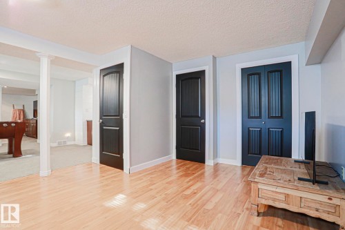 Light wood-finish flooring, white trim, and light gray wall paint - 2 Hillview Crescent, Sherwood Park, AB 