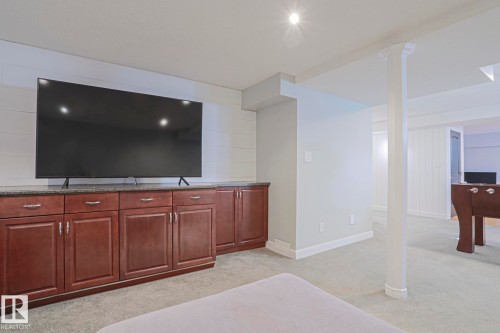 Built-in cabinetry with dark wood finish, light-colored countertop, and recessed lighting - 2 Hillview Crescent, Sherwood Park, AB 