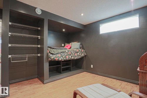 Built-in bed nook with recessed lighting, integrated shelving, and wood-finish flooring - 2 Hillview Crescent, Sherwood Park, AB 