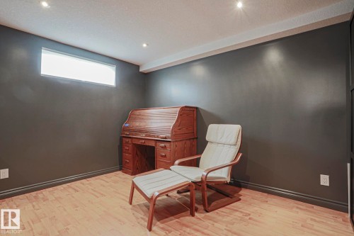 Recessed ceiling lighting, horizontal window, light wood-finish flooring, dark wall paint, white trim - 2 Hillview Crescent, Sherwood Park, AB 