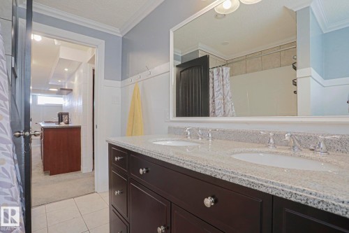 Dual vanity with a speckle-patterned countertop, under-mount sinks, and chrome-finish faucets - 2 Hillview Crescent, Sherwood Park, AB 