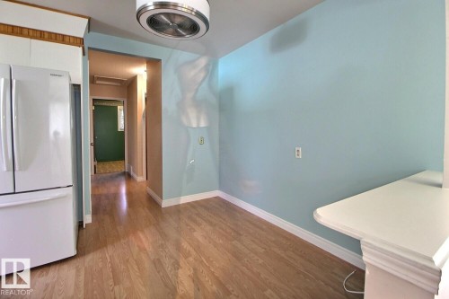 Wood-finish flooring with white trim - 4420 117A Street Nw, Edmonton, AB 