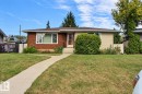 Brick and stucco exterior, front yard with mature landscaping, concrete walkway, and a prominent front entrance - 4420 117A Street Nw, Edmonton, AB 