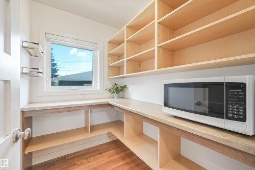 Built-in shelving, expansive countertop space, natural light, and wood-finish flooring - 8212 148 Street Nw, Edmonton, AB 
