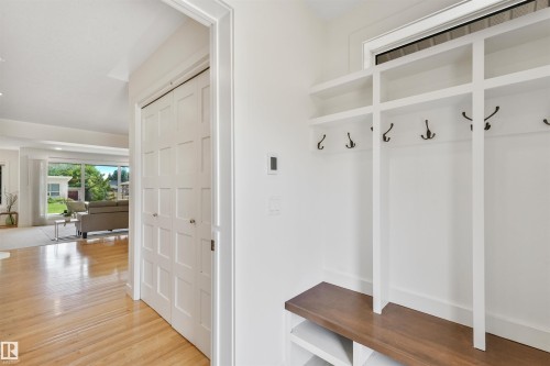 Built-in storage bench with wood-finish top and coat hooks - 8212 148 Street Nw, Edmonton, AB 